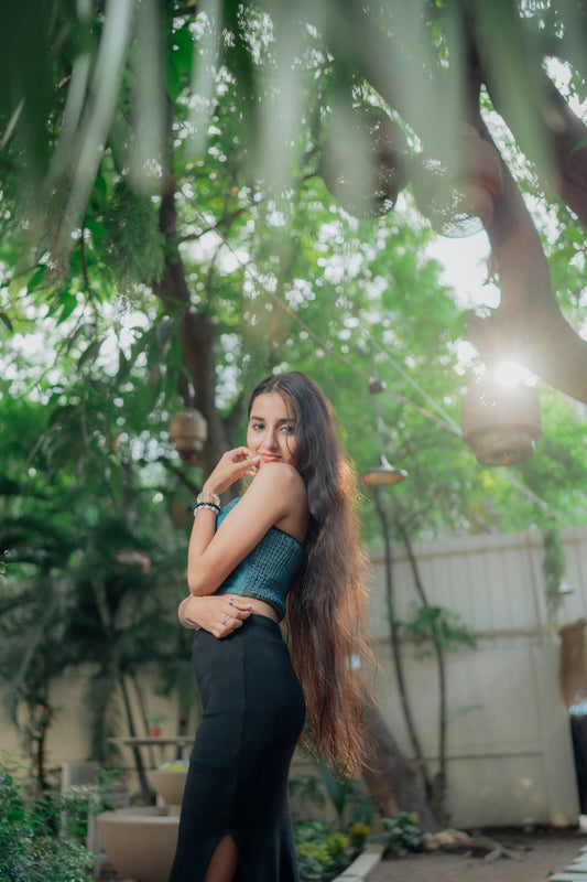 Young woman with long hair in a garden